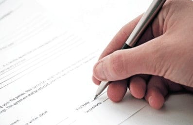 Hand filling out a form above RCFE License Application product card.